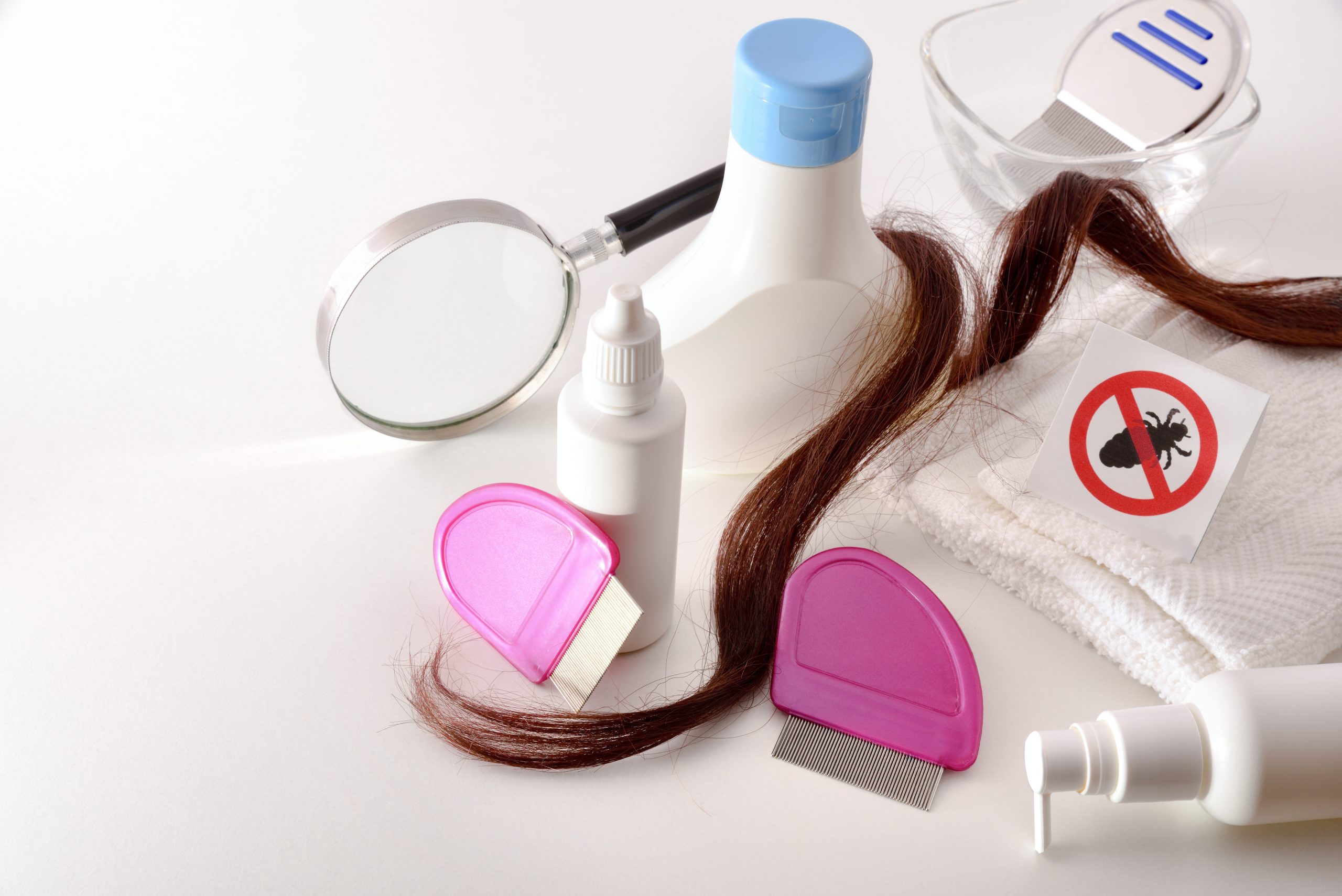 Bottles and comb for an enzyme-based lice treatment article