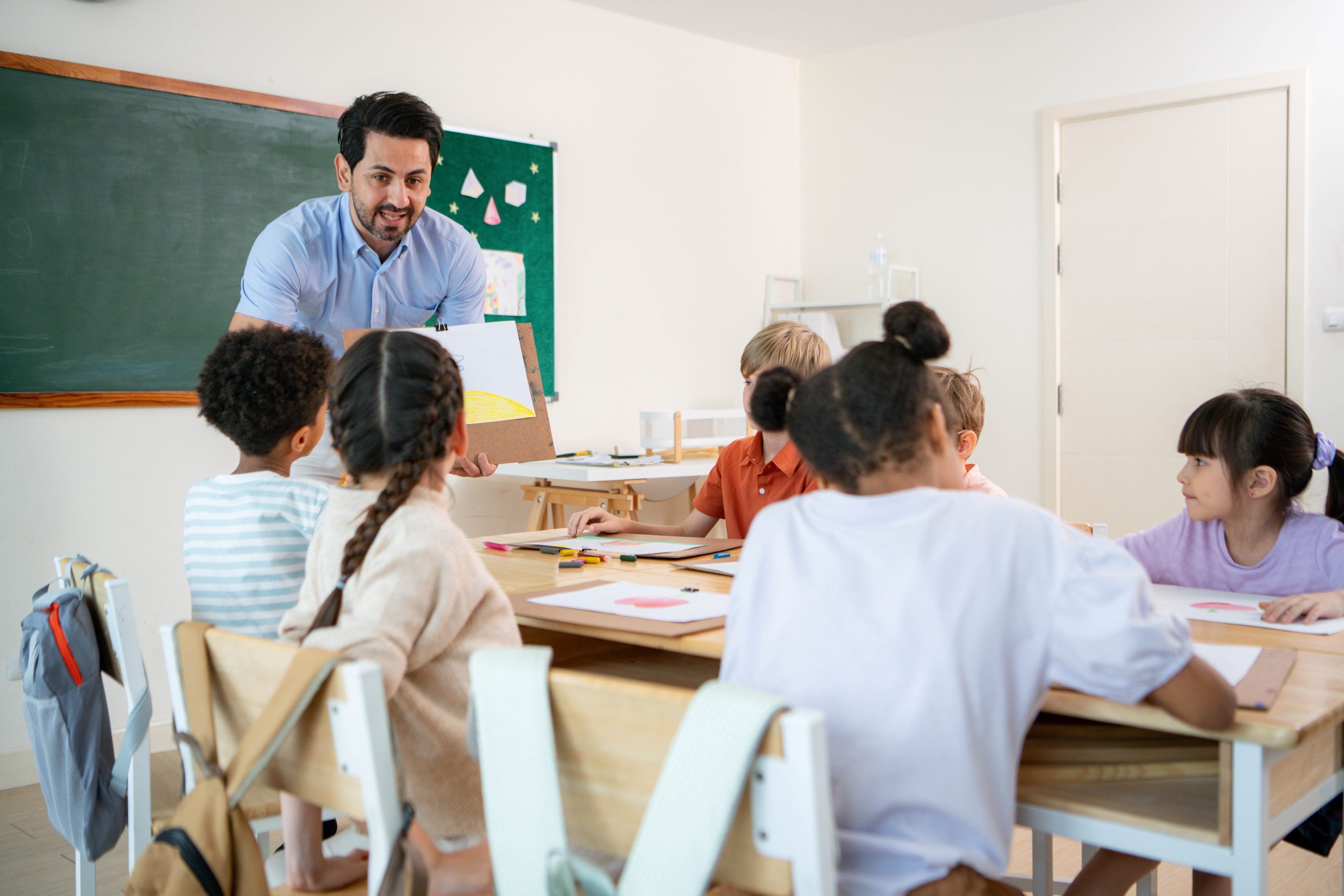 Teacher presenting to children in a classroom