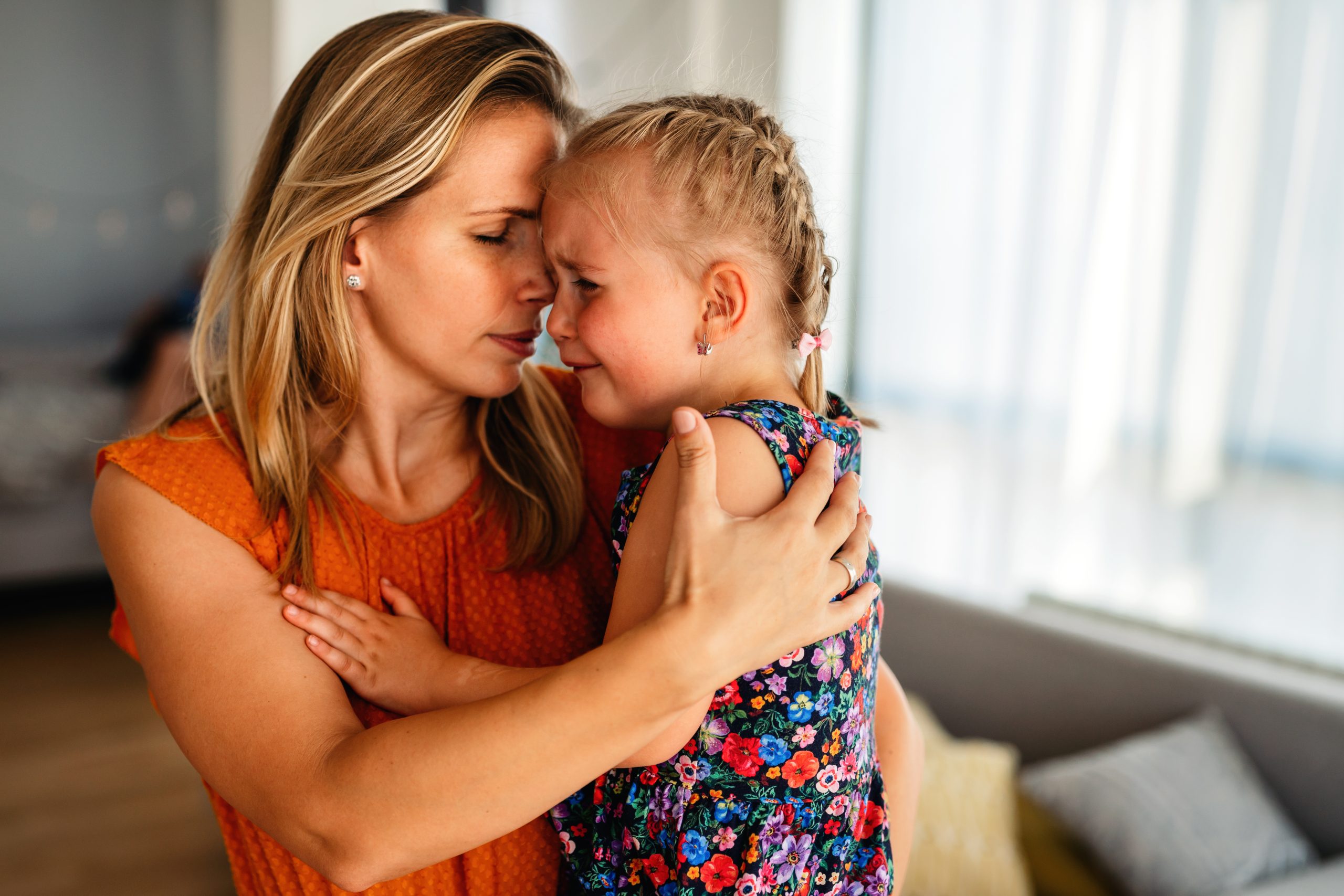 Mother comforting a child during a head lice stigma article
