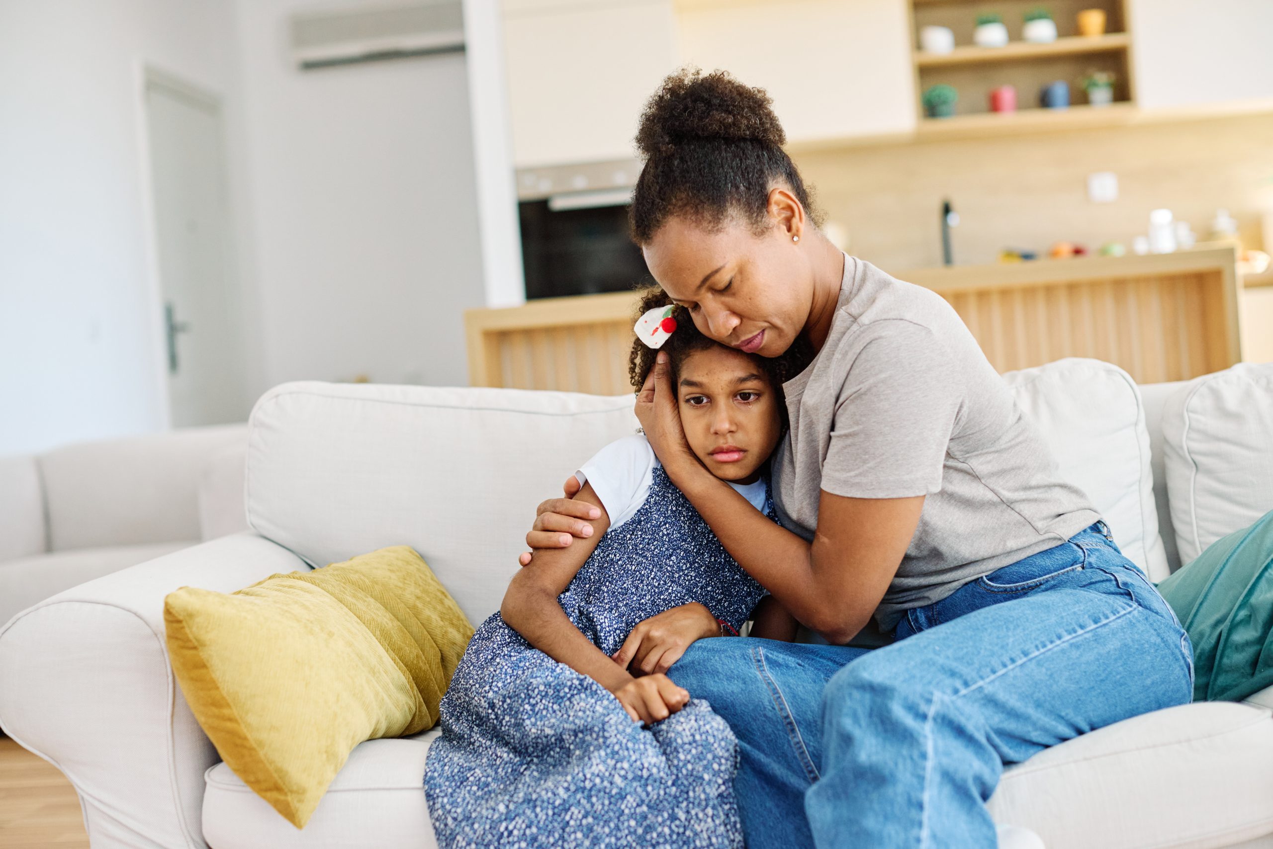 Mother comforting a child during a calm conversation at home