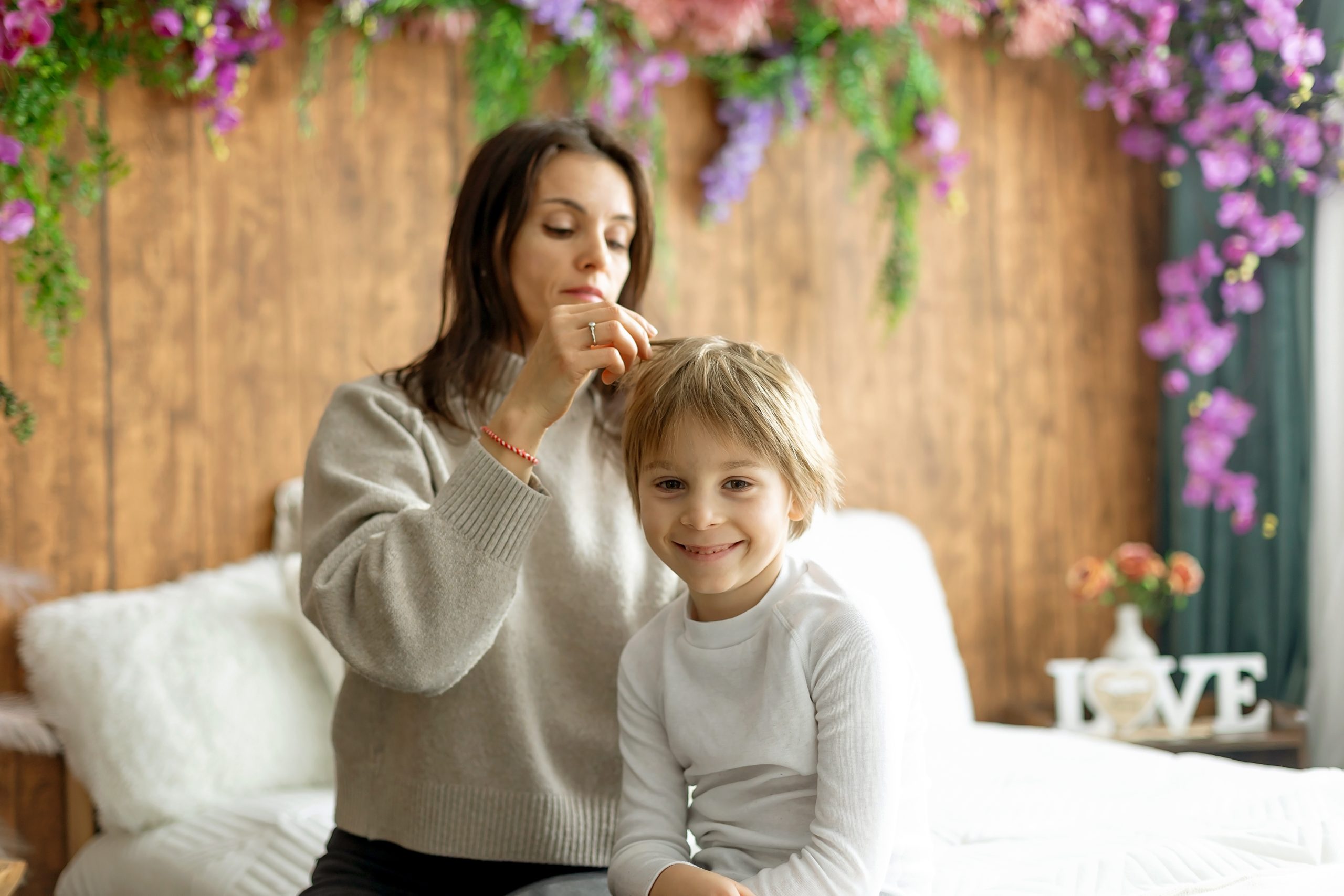 Mother checking her child's hair for lice as part of a family head check